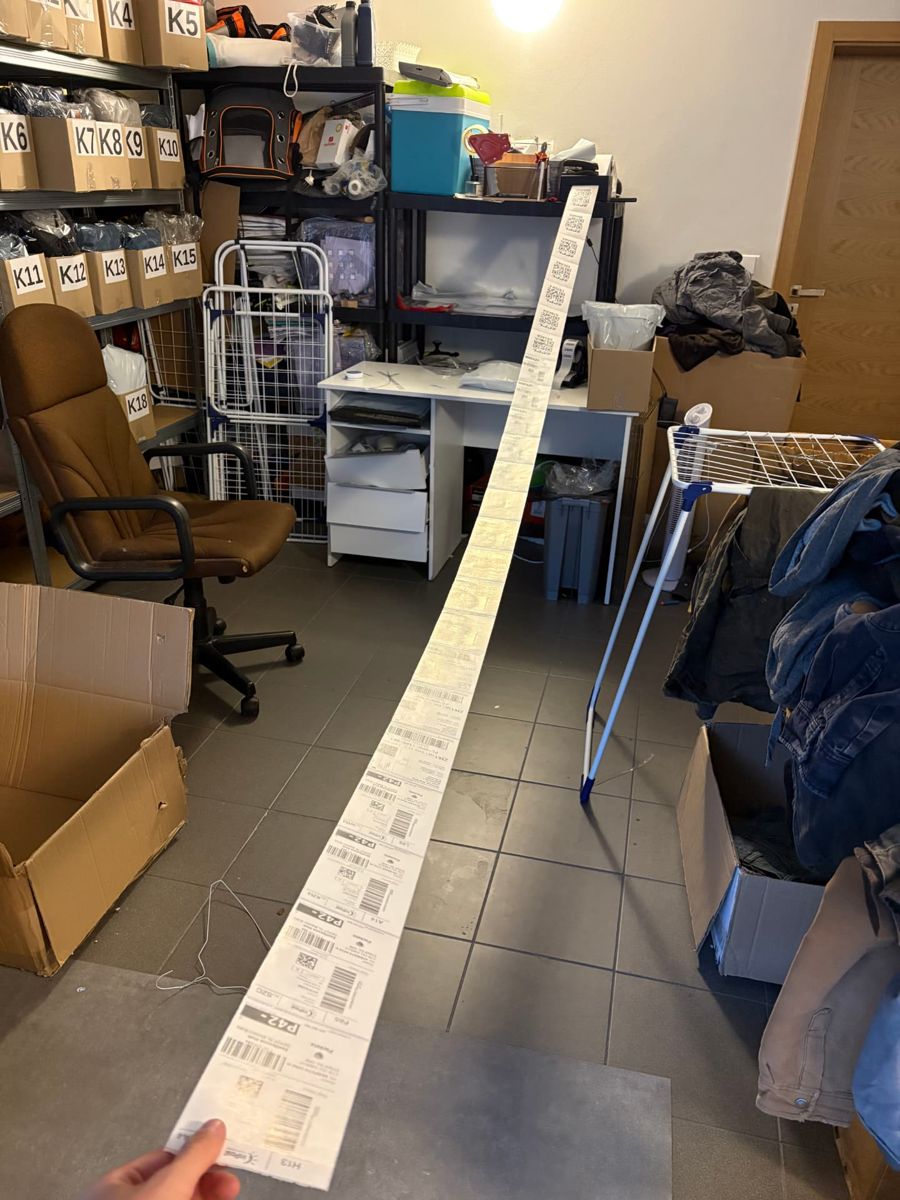 Metres of printed shipping labels rolled out across the packing room