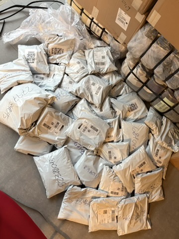 Pile of packed parcels labelled and ready for dispatch